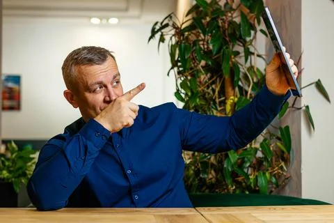 Man Gesturing Enthusiastically During Tablet Use Stock Photos