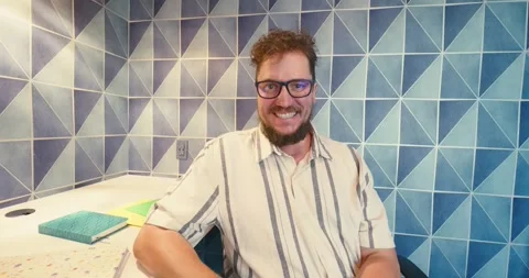 Man Gesturing in Modern Blue Tiled Office Video stock 323581080