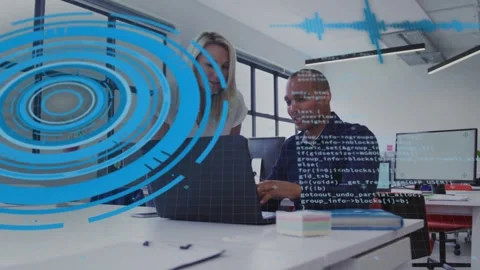 Man gesturing then typing while woman leaning over laptop, reviewing tech code Stock Footage 331333553