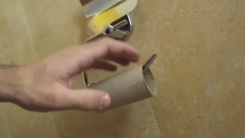 Man get frustrated over empty roll and crunches it in anger Stock Footage 82312317