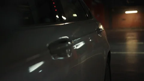 Man get out of the car at evening night time on parking light male street Video stock 108401099