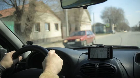 A man gets into the car and turns on the navigator on the smartphone Video stock 106683473