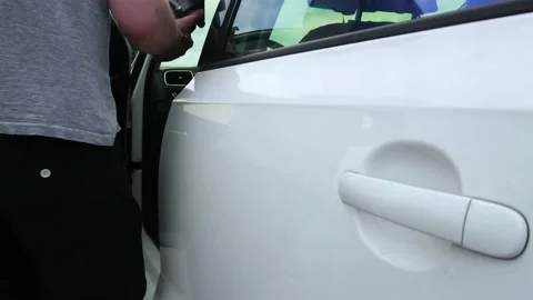 The man gets into the car, soft focus background Stock Footage 157105304