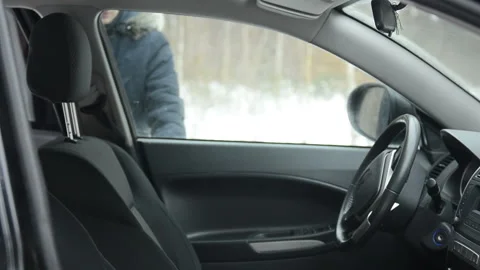 A man gets into a car in winter Stock Footage 101610375