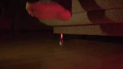 A man gets up from the couch after resting in the dark. Stock Footage 107960574