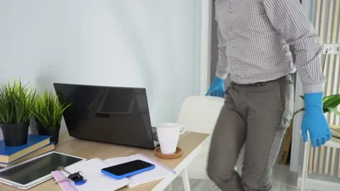 Man gets up from desk, takes white cup, leaves. End of working day at home Stock Footage 131472560