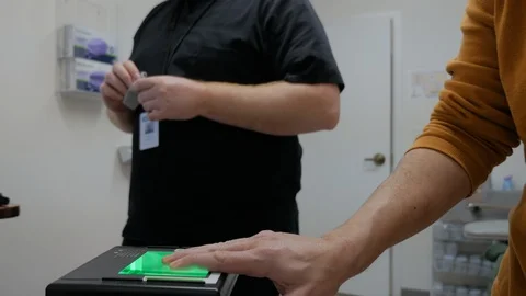Man Gets Finger Printed in lab Stock Footage 102246436