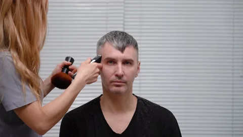 Man gets haircut at home.  while woman uses hair clipper to shorten his hair. Stock Footage 153483247