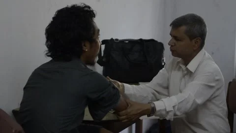 A man gets his checked for leprosy in pop up clinic in southern Nepal Stock Footage 252368191