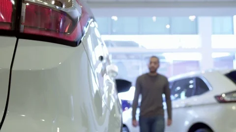 Man gets inside the crossover at the dealership Stock Footage 73543191