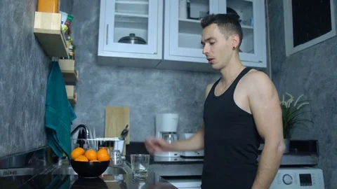 Man gets mandarin juice and drinking that seamless loop Stock Footage 78815401