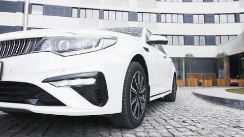 Man gets into a new white car, front view Stock Footage 123862483