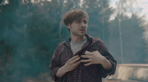 Man gets out of the car and lights up the cigarette Stock Footage 63333050