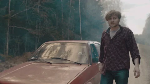 Man gets out of the car and lights up the cigarette Stock Footage 63333286