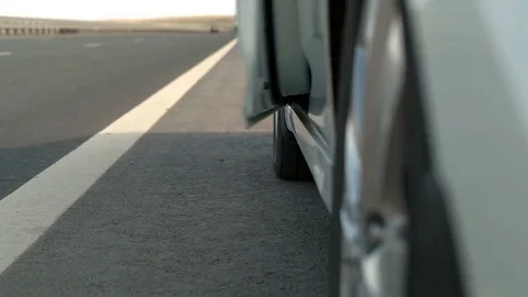 A man gets out of the car on the road Video stock 75171041