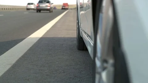 A man gets out of the car on the road Stock Footage 75172165