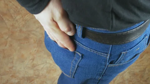 The man gets out of the pocket of the pants the bag of medical marijuana. Stock-Footage 128302541
