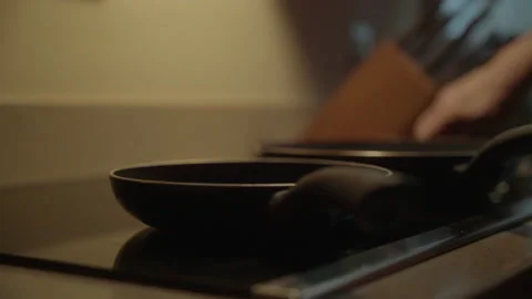 Man gets pans out and starts cooking Stock Footage 168113247