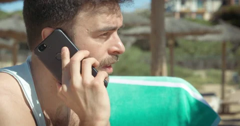 Man gets phone call on the beach Video stock 205022827