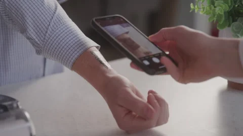 Man Gets QR Code on Inside of His Wrist Scanned by Smartphone for Transaction Stock Footage 208797955