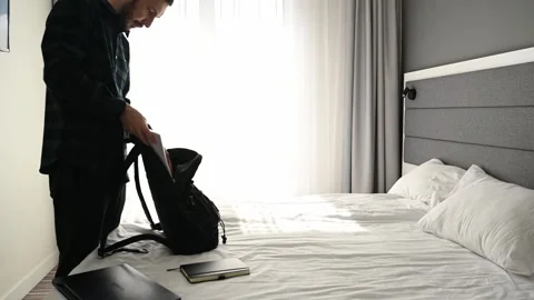 A man gets ready for work he puts his documents laptop notebook notebook in his Stock Footage 307666850