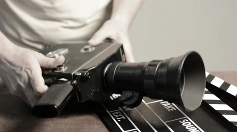 Man gets a spring mechanism on a retro movie camera Video stock 63386786
