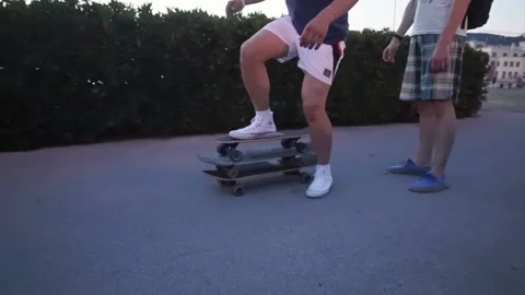 Man gets up on three skateboards and rides them Video stock 102425413