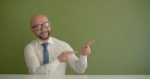 A man gets up from under the table and presents Stock Footage 267087940