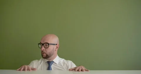 A man gets up from under the table excitedly Stock Footage 267088245