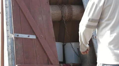 Man gets water from a well Stock Footage 11896087