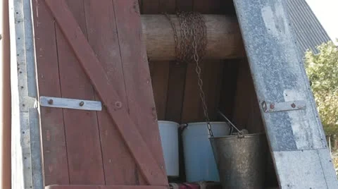 Man gets water from a well Stock Footage 11896200