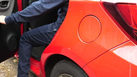 Man getting in and out of red car rear seat Stock Footage 199833015