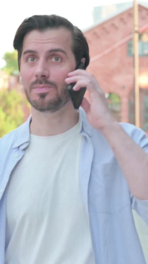 Man getting Angry on Call while Walking in Street, Vertical Video Stock-Footage 339665227