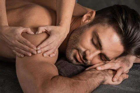 Man getting back massage at spa Stock Photos