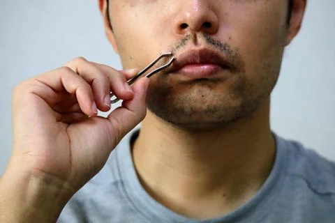 A man getting a beard removal treatment Stock-Fotos