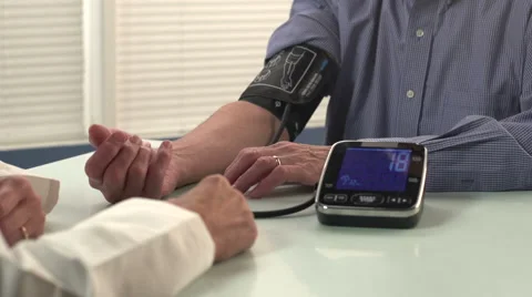 Man getting blood pressure checked by doctor - close, dolly Video stock 43600567