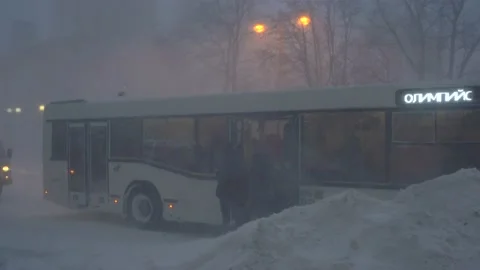 Man getting bus during a snowstorm Stock Footage 169528817