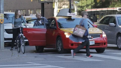 Man Getting Into a Cab at Rush Hour Stock Footage 70637273