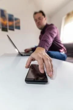 Man getting a call and taking his mobile phone Stock Photos