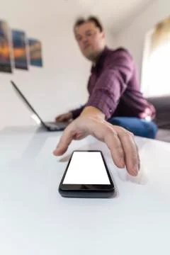 Man getting a call and taking his mobile phone Foto stock
