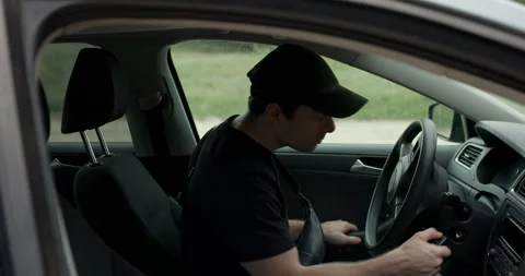 Man getting into car and starting engine for forest road trip, audio included Stock Footage 340829062