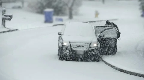 Man Getting into Car During Snow Storm in Slow Motion Stock Footage 46100110