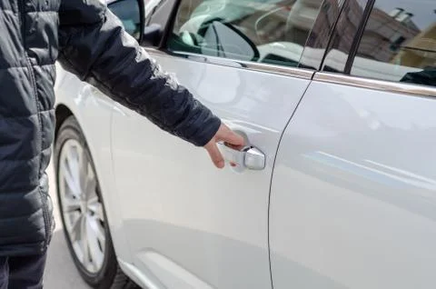 The man is getting into a car Stock Photos