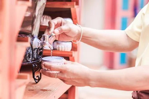 Man getting a cold, refreshing drink from the water cooler. Foto stock