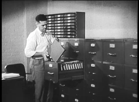 MAN GETTING DOCUMENTS FROM FILING CABINET (1945) Stock Footage 160105572