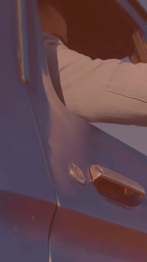 Man getting in his car and adjusting the side view mirror Stock Footage 344706659