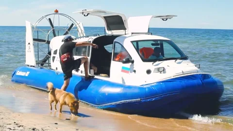 Man getting in hovercraft on Baikal, beach attraction, technology air cushion Video stock 142436404