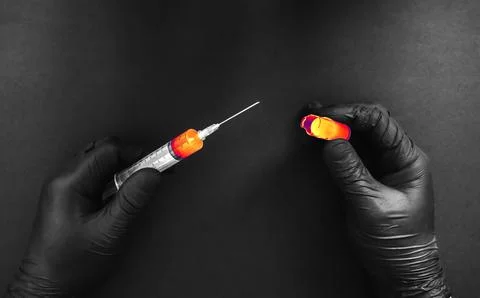 Man is getting an injection from broken ampule. Medical treatment of a low .. Stock Photos