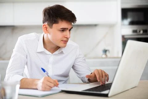 Man getting knowledge using internet and laptop at home Stock Photos