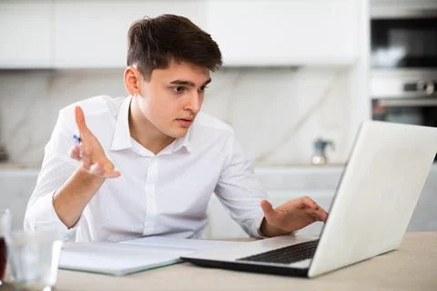 Man getting knowledge using internet and laptop at home Stock Photos